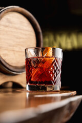 Close up of tum alcoholic cocktail  with a beautiful reflection on a bar counter, soft light, dark tempting atmosphere