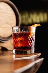 Beautiful and posh photo of negroni cocktail for a mixology magazine cover, close up, dark atmosphere