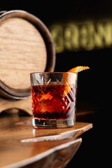Beautiful and posh photo of negroni cocktail for a mixology magazine cover, close up, dark atmosphere