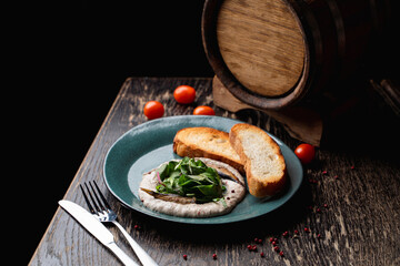 Fish cream with sprat and fresh bread, top view on a black wooden table, modern scandinavian cuisine