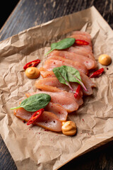 Close up of raw chicken breast as a gourmet delicatesse, warm colors, appetizing shot