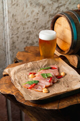 Chicken breast snack with a point of light beer in a pub