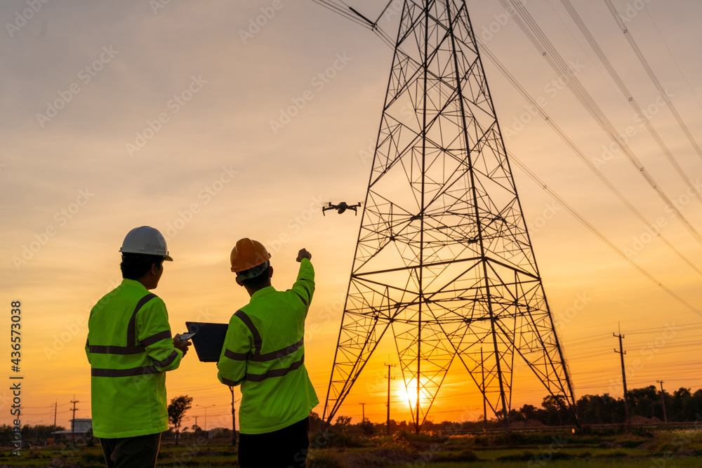 Wall mural team work of engineers location help technician use drone to flying inspect equipment instead of wor
