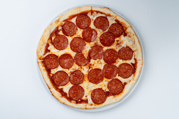 Pepperoni pizza isolated on white studio background, flat lay