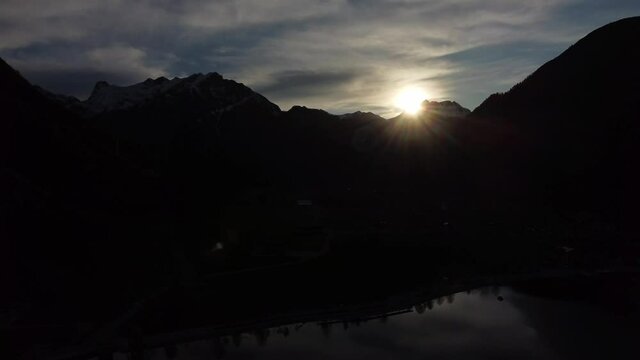 Sunset and silhouettes of mountain peaks, aerial view. Achen lake in Tyrol, Austria.