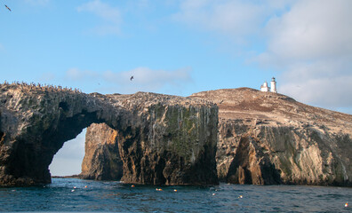 Fototapeta na wymiar Anacapa Island arch rock and lighthouse in the Channel Islands Naitonal Park offshore from Santa Barbara California USA