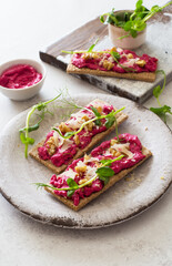 Open sandwiches with beetroot hummus, parmesan cheese and walnuts