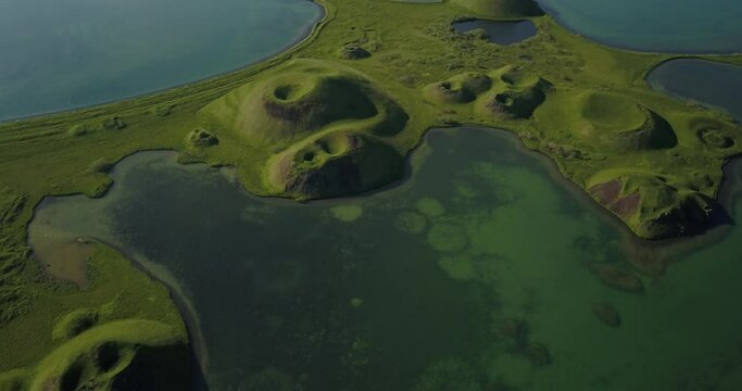 Aerial view over volcanic pseudo craters in lake Myvatn 
drone view over North Iceland pseudo craters, February 2021 
