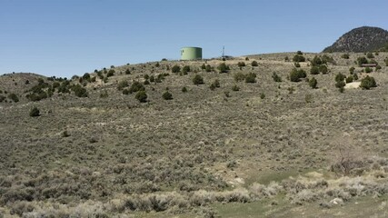 Low aerial pass over the wilderness of Eureka City Utah flying towards the Water Tower