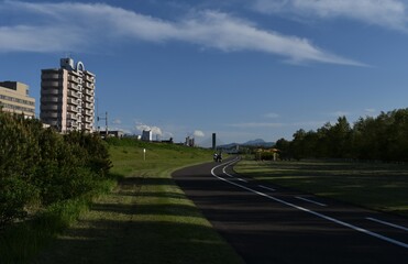 Sapporo Japan May 20 2021 The pleasant cycling road along with the Toyohira river with the clear blue sky
