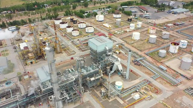 Drone rotates over Shale Oil Refinery. Here comes crude oil and refined fuel is manufactured. Methanol production plant in Vaca Muerta, Neuqu&eacute;n Patagonia Argentina