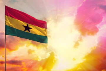 Fluttering Ghana flag in top left corner mockup with the space for your text on beautiful colorful sunset or sunrise background.