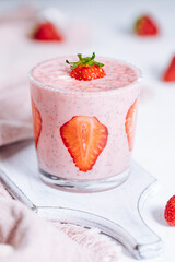Strawberry and chia yoghurt served in glass on a bright background 