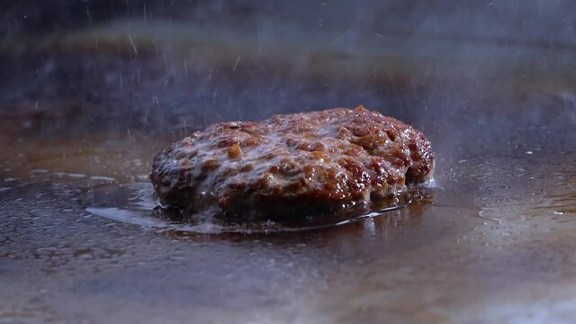 video of  hamburguer on grill fliped