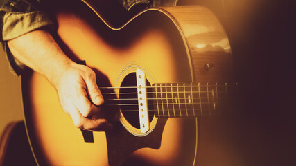 Close up of guitarist musician playing guitar on stage.
