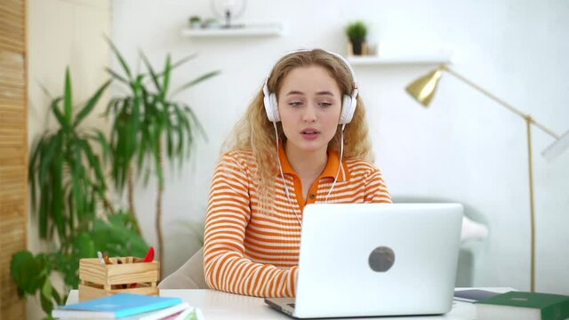 Woman talk, gesture and explain on online meeting laptop conference at home Spbas. Young 20s blonde