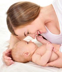 Mother and baby playing and smiling. Happy family.