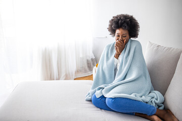 Woman feeling freeze and wrap up in a blanket. Sorowful minded woman cought a cold, she has running...
