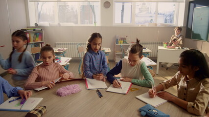 Students preparing for lesson in classroom. Teacher beginning lesson at school