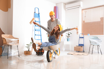 Happy young couple having fun during repair in their new house