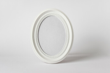 Mockup template with round oval standing photo frame on white background.