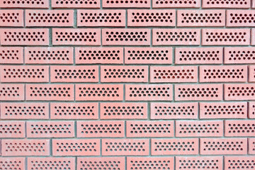 Red perforated bricks wall background