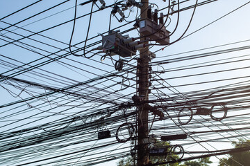 The electric pole has too many wires.