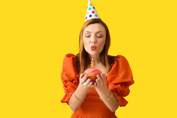 Beautiful woman celebrating birthday on color background