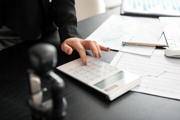 Female accountant with calculator working in office, closeup