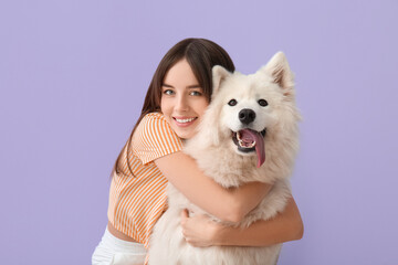 Beautiful woman with cute dog on color background