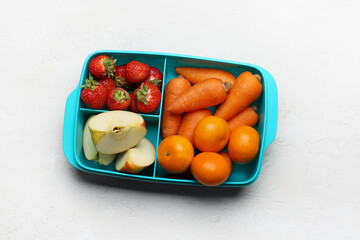 Lunchbox with tasty food on light background