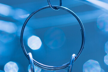 Abstract clothespin loop on blue background.