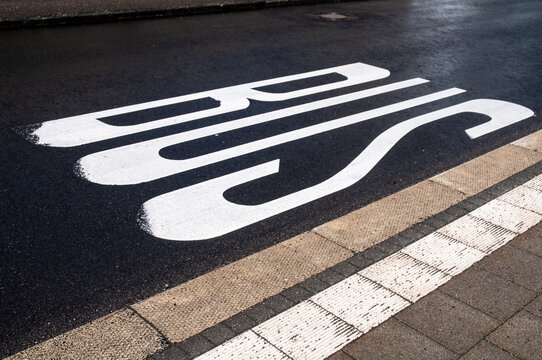 a tarmac street marked as a bus stop