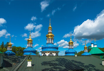 Fototapeta na wymiar The city of Pechora. Russia. Uspensky Pskov-Pechersk Monastery. The roof and domes of the Intercession Church, built over the Assumption Cave Temple