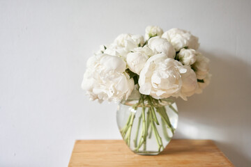 White peonies in a glass vase. Beautiful peony flower for catalog or online store. Floral shop concept . Beautiful fresh cut bouquet. Flowers delivery