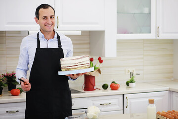 Master pastry chef in front of a desk. Cooking desserts at home. The Armenian man is engaged in confectionery.