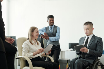 Group of successful economists having discussion at meeting in office
