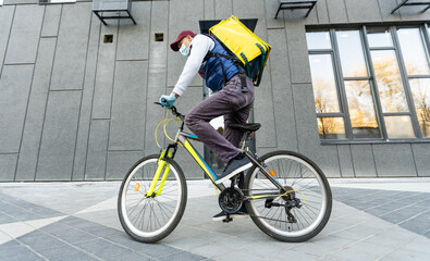 Young delivery man with yellow backpack takeaway concept