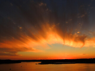 Fototapeta na wymiar brilliant sunset in osage beach, over the water at lake of the ozarks, missouri 
