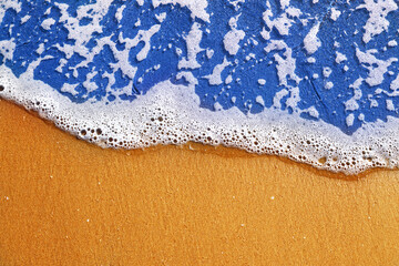 Soft sea wave with foam on sand beach, text space. sea landscape background