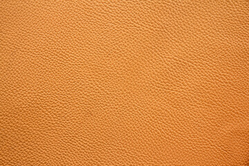 close up of orange or brown leather sheet texture background 