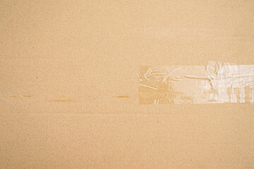 Brown paper box or Corrugated cardboard sheet with tape texture 