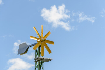 Decorative wind turbine in a garden in the countryside.