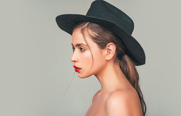 Young woman in fashion hat. Girl wearing hat, studio.