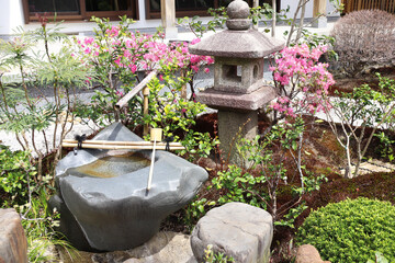 Stone lantern and wash-basin in traditional japanese garden, Kamakura, Japan