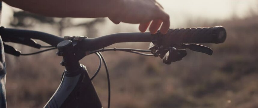 Biker hand hold handlebar sport bike summer sunset light lens flare