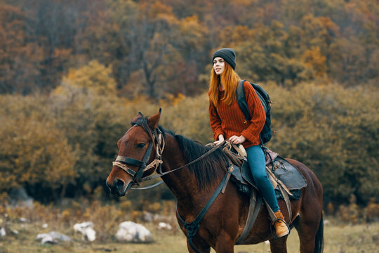 woman riding a horse on nature mountains travel adventure