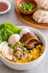 Bak chor mee. The noodles are tossed in vinegar, minced meat, pork slices, pork liver, stewed sliced mushrooms, meat balls and bits of deep-fried lard