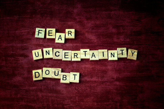 Fear, uncertainty, and doubt, FUD concept in sales, marketing, public relations, politics, polling and cults. Red grunge pattern background.