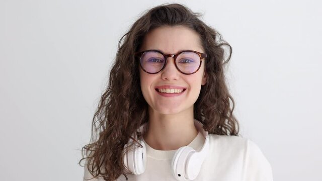 Happy young adult hipster woman smiling, wearing glasses looking at camera posing indoors Spbi.